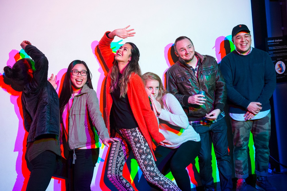 02_AfterDark - visitors pose in front of colored shadows Exploratorium