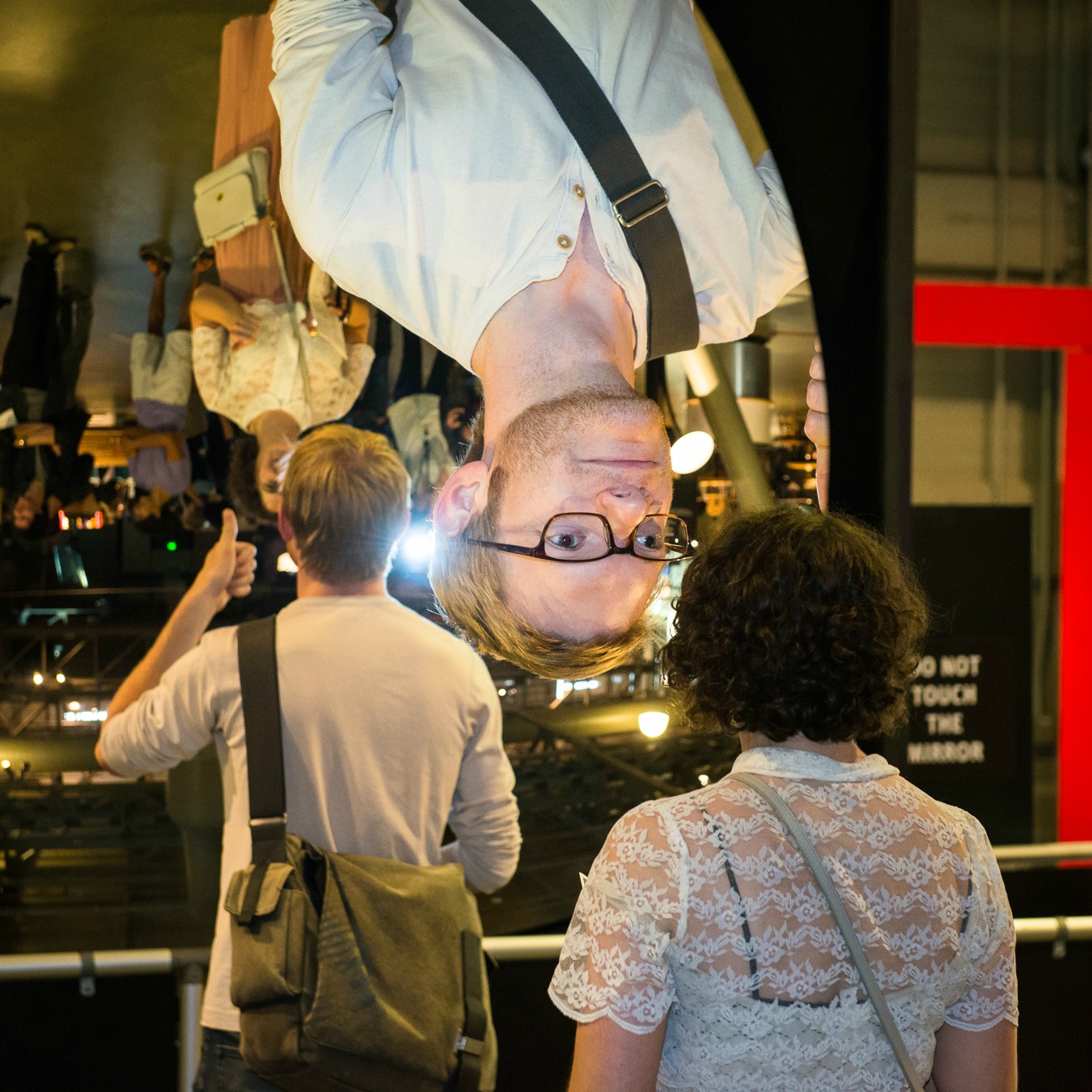 05_AfterDark - visitor explores a giant mirror at Exploratorium