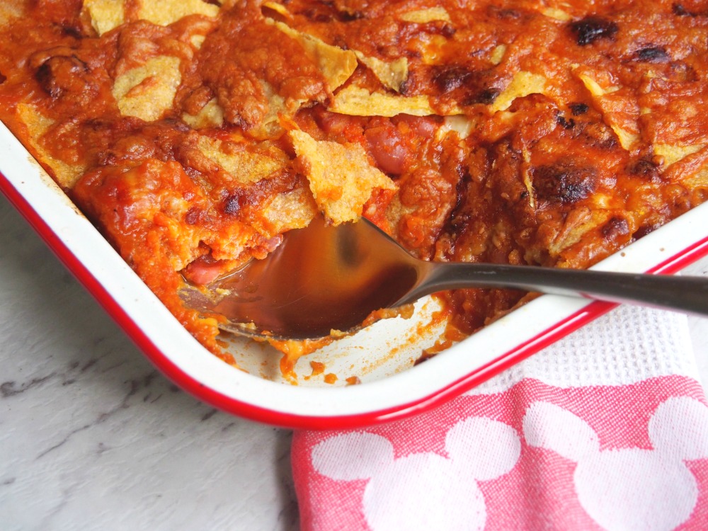 Mexican beans with cheesy taco topping serving