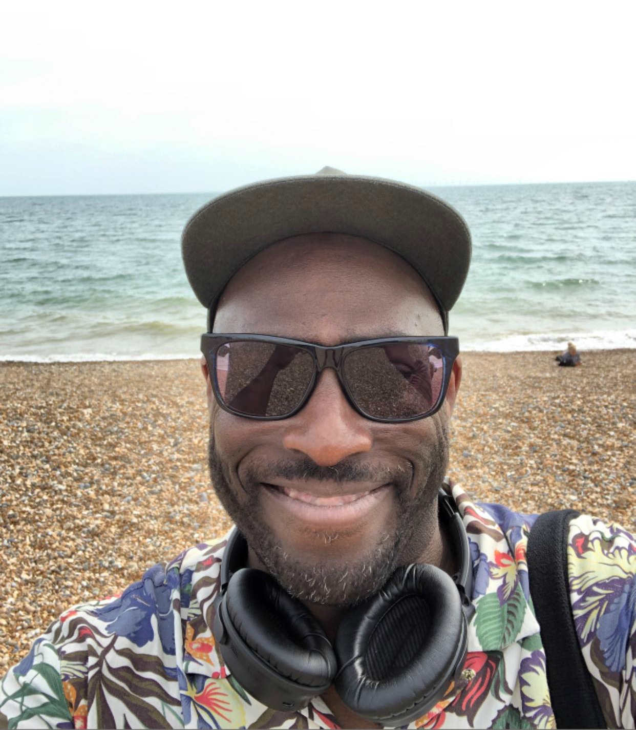 Mike Gayle with headphones at the beach