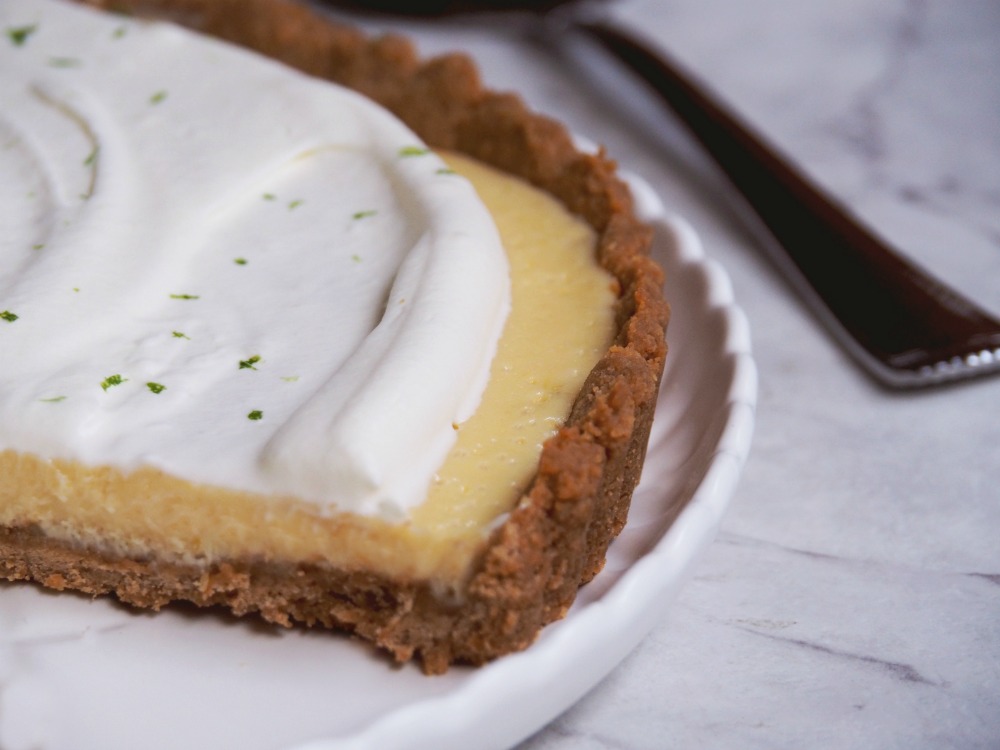 key lime pie with slice cut out