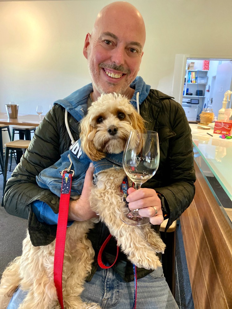 dad and dog tasting wine