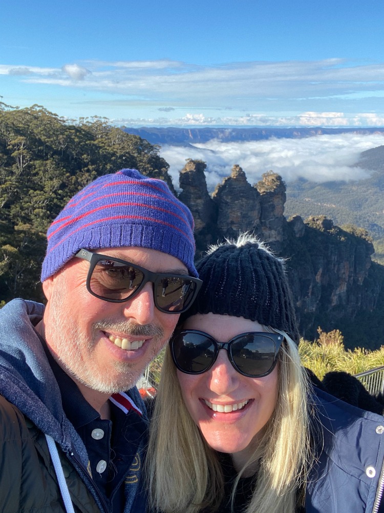 man and woman with three sisters in the background