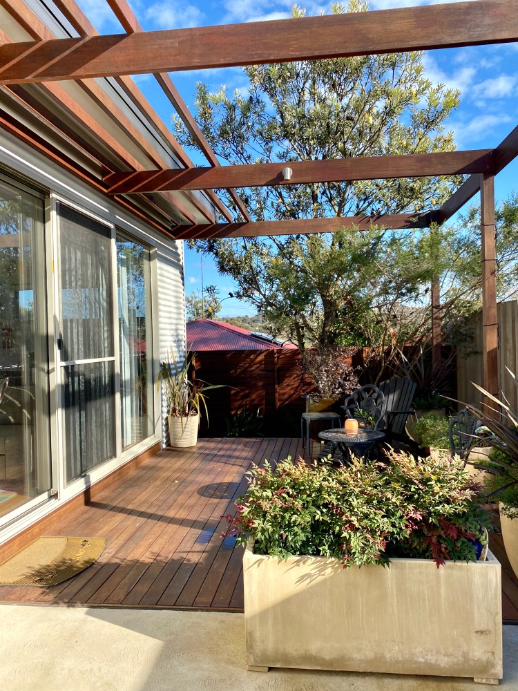 timber deck with plants and chairs