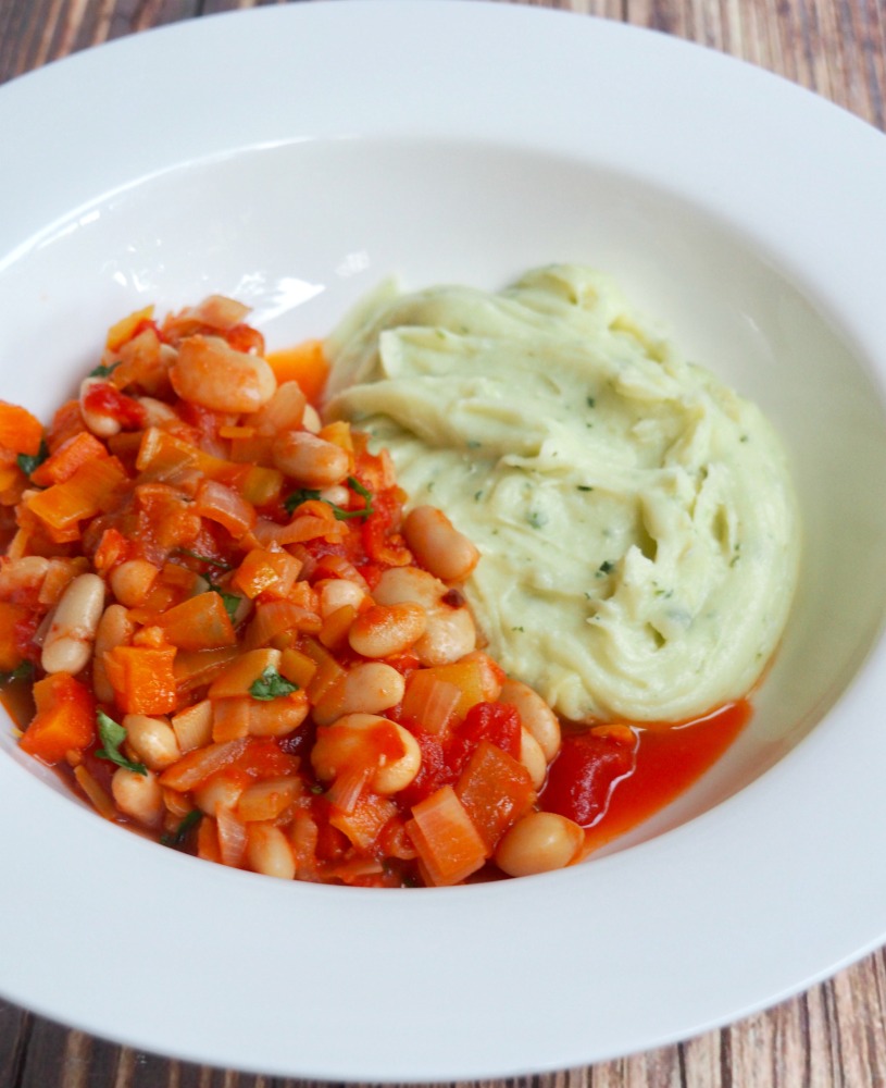 cider bean stew with cheddar and parley mash on a plate