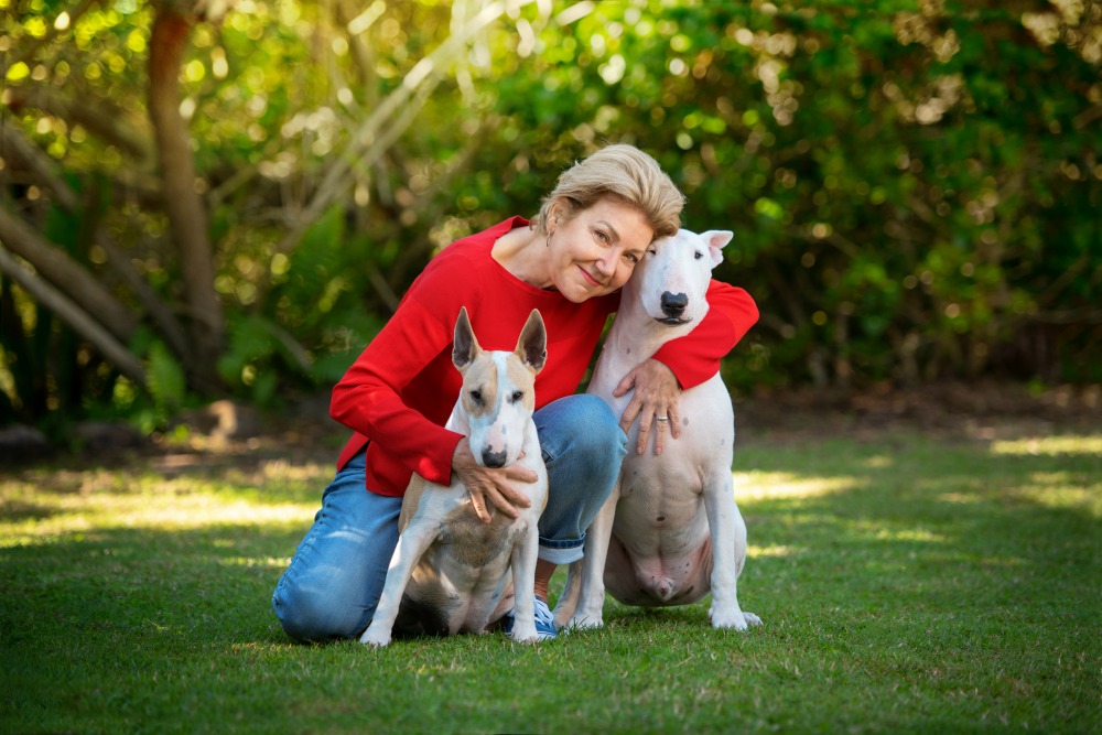 woman hugging her 2 dogs