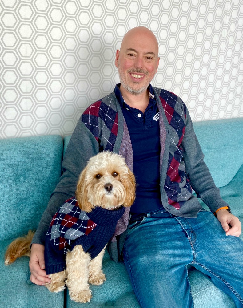 man and cavoodle wearing matching knitwear