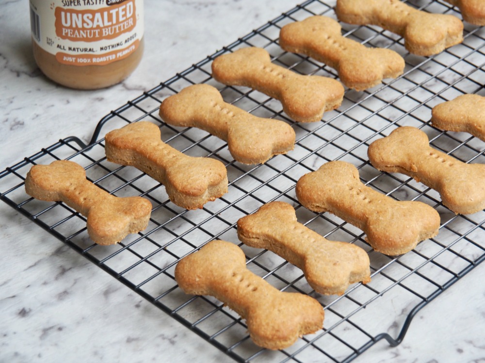 cooling rack full of peanut butter dog biscuits