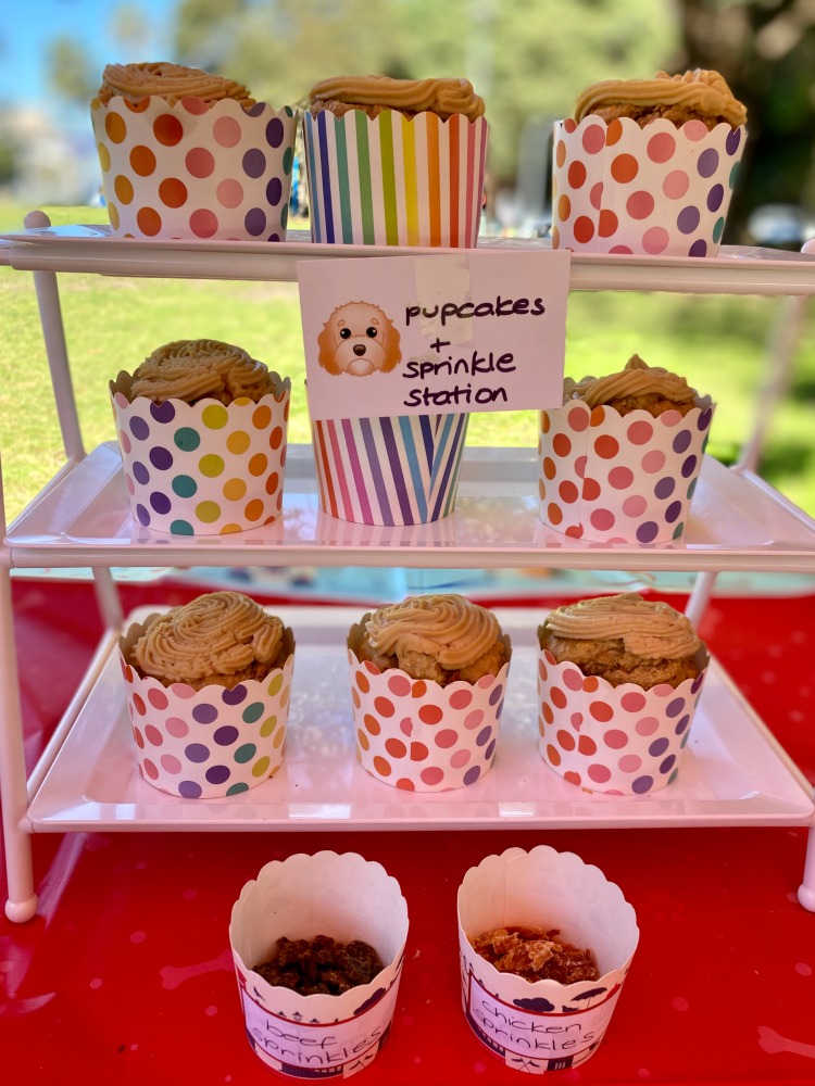 pupcakes on cake stand with sprinkles in cups
