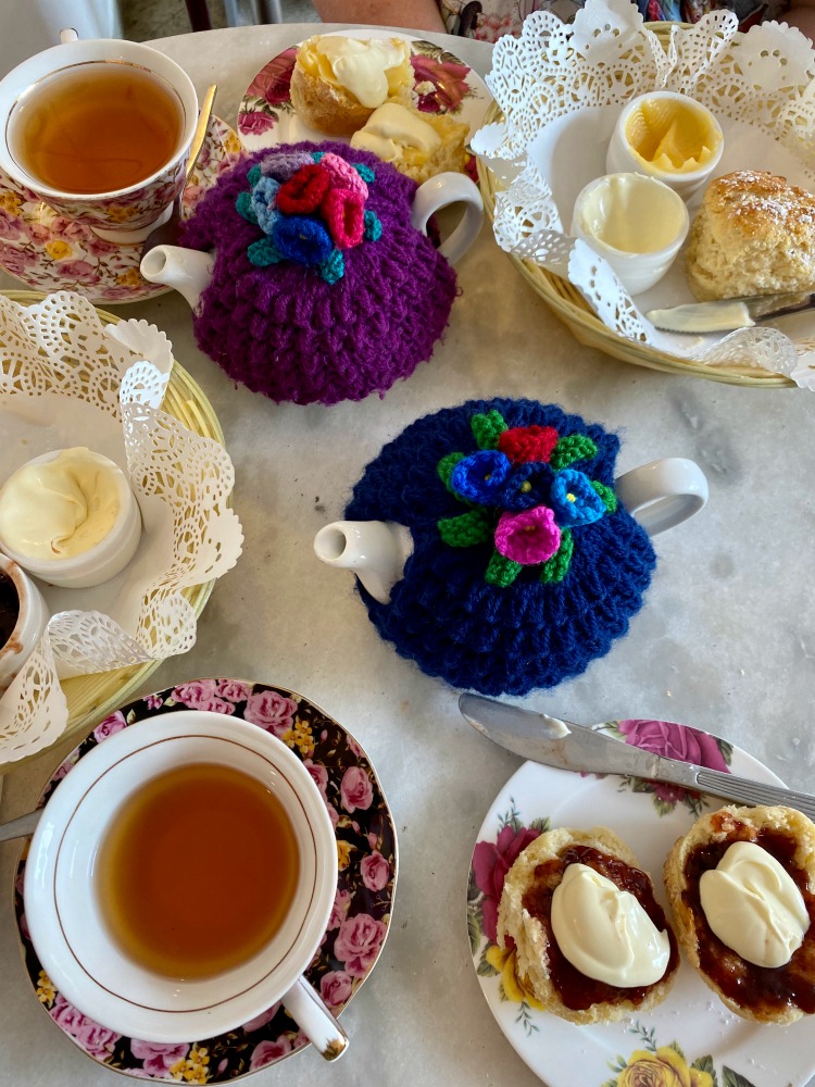 teapot teacups and scones on a table