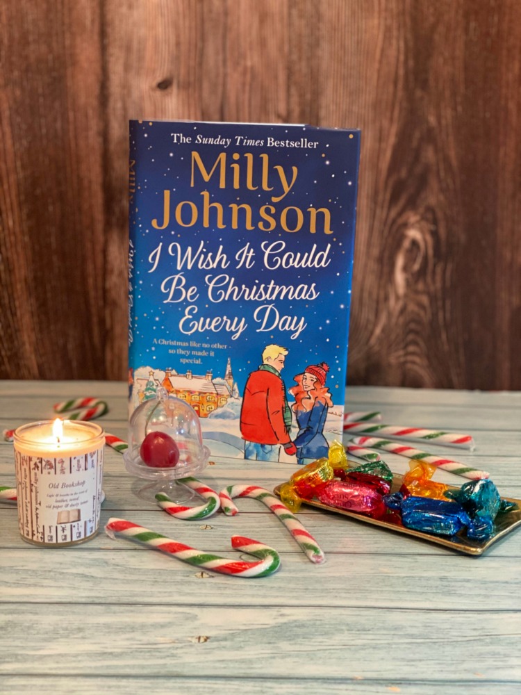 christmas novel surrounded by candy canes and candles