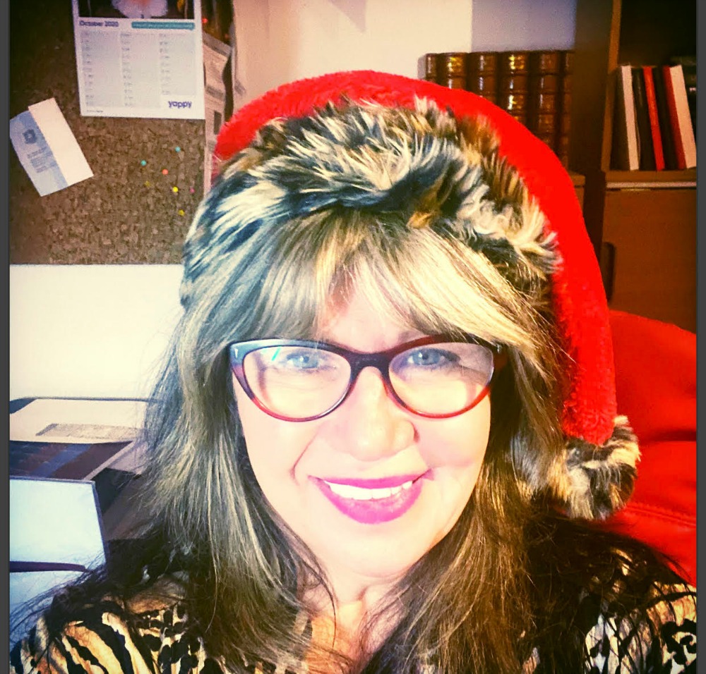 woman wearing glasses and a Santa hat