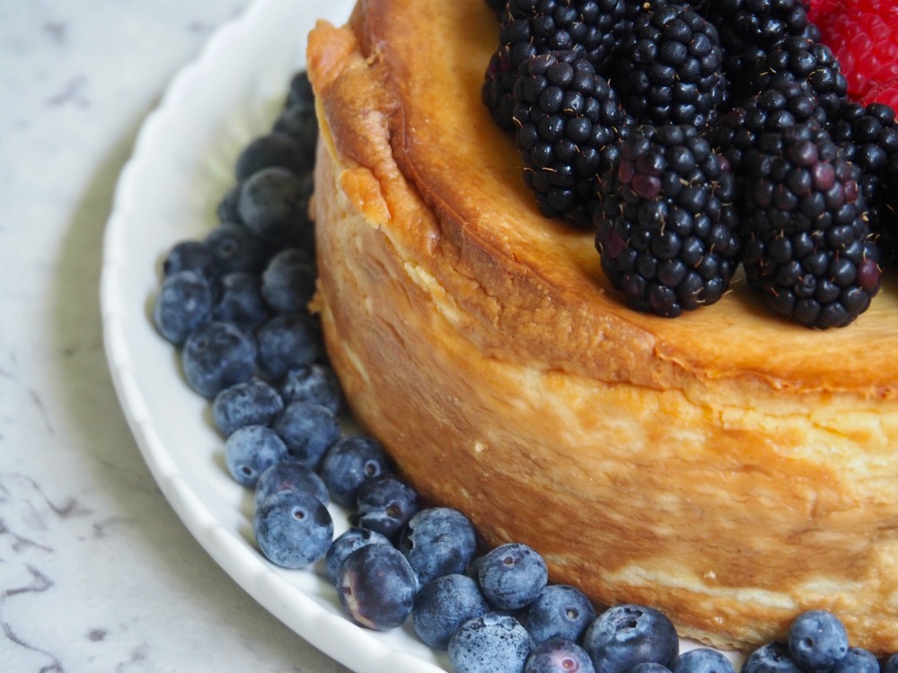 corner of crustless cheesecake topped with blackberries