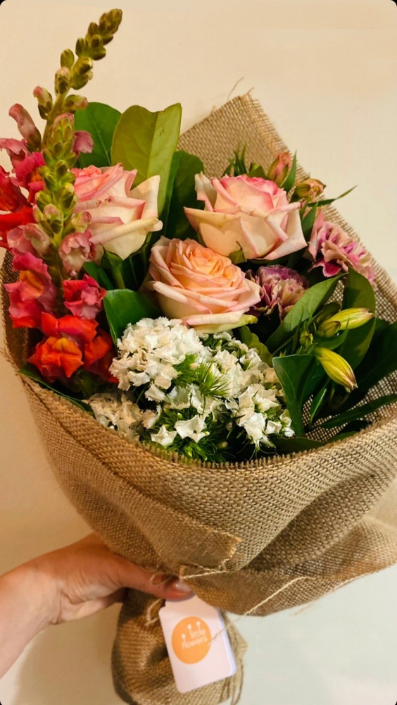 hand holding a bouquet of flowers