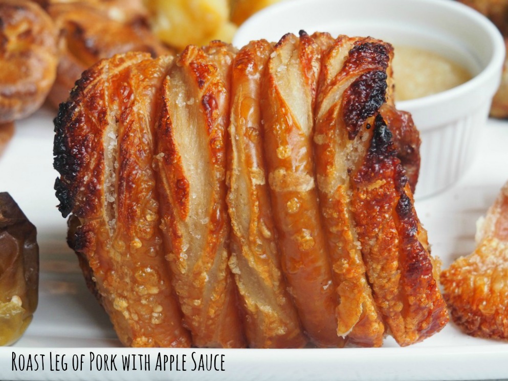 roast leg of pork on a plate covered in crackling