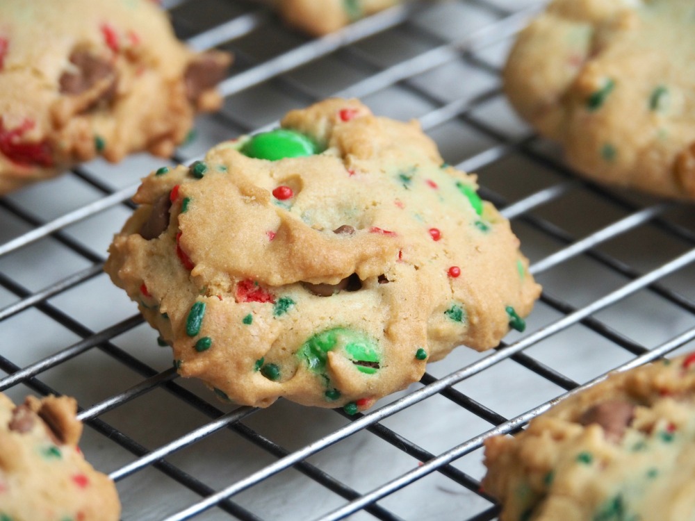 fully loaded christmas choc chip m and m cookies on cooling rack