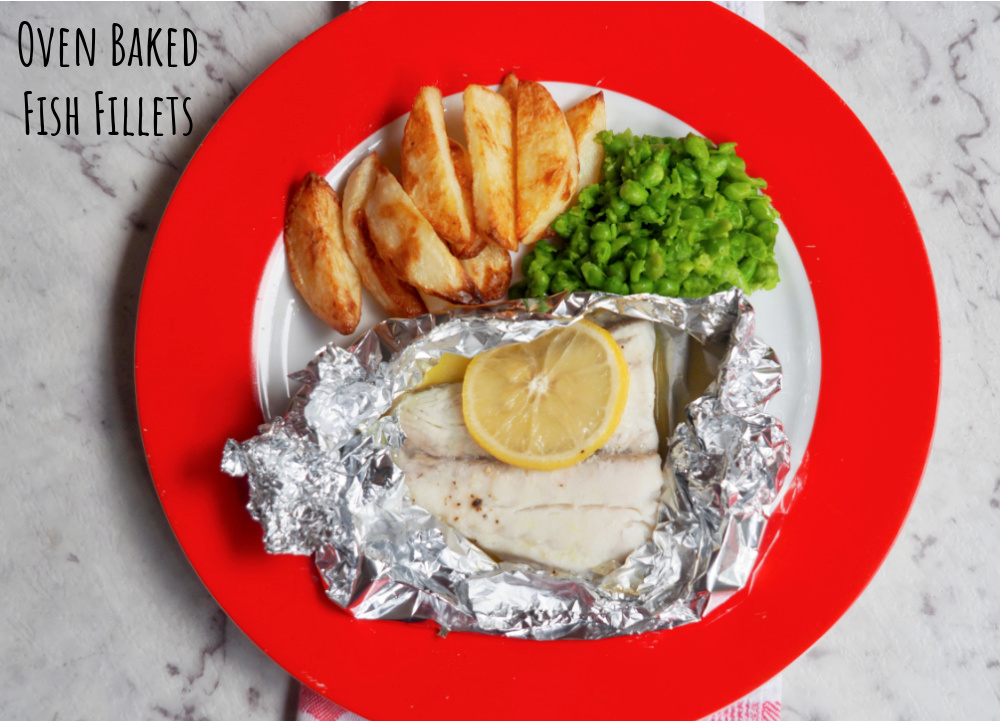 oven baked fish fillets with a slice of lemon on top handcut chips and smashed peas