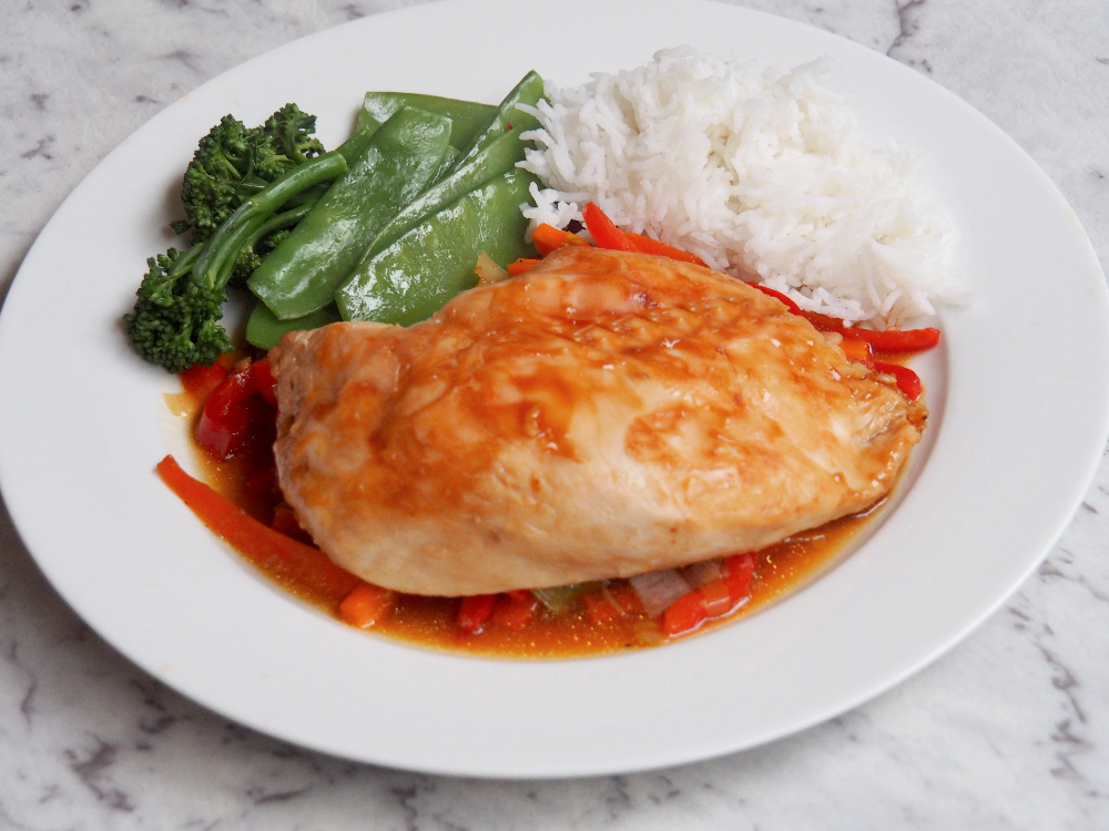 chicken oyster parcels on plate with rice and steamed greens