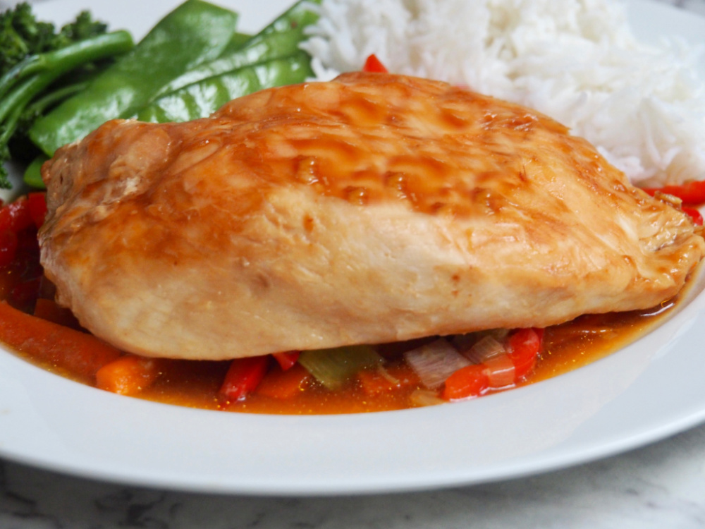 sticky oyster chicken parcels with rice and steamed greens in background