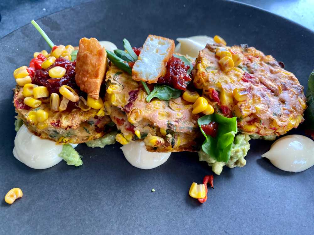 fritters on a long black plate with garlic aioli