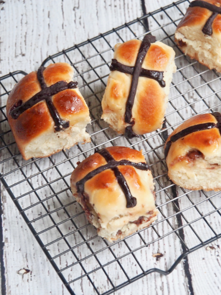 choc fudge hot cross buns on a cooling rack