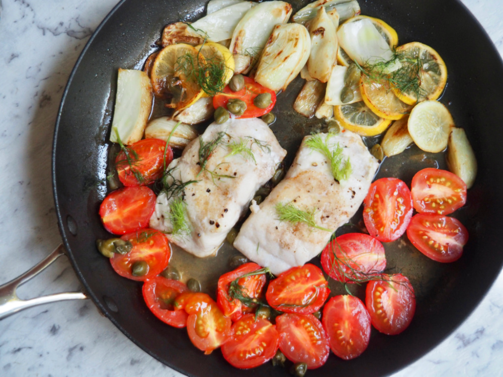 lemon fish with fennel and capers in a pan