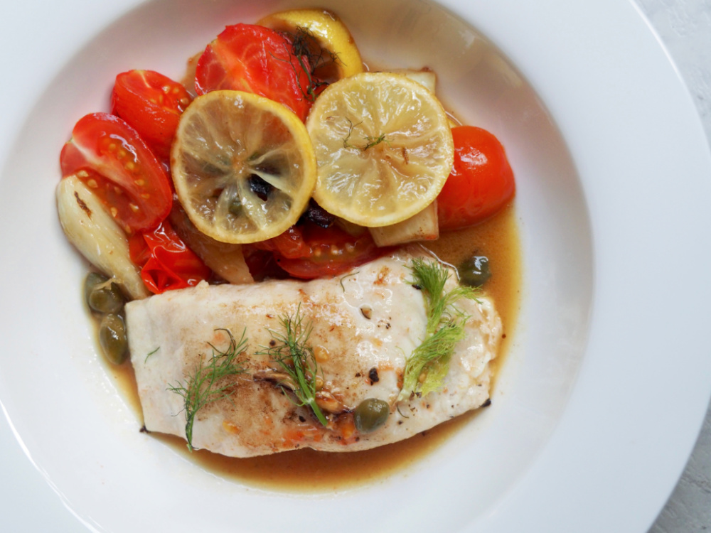 lemon fish with fennel and capers on a plate