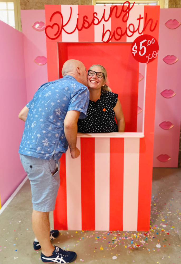 couple kissing in kissing booth