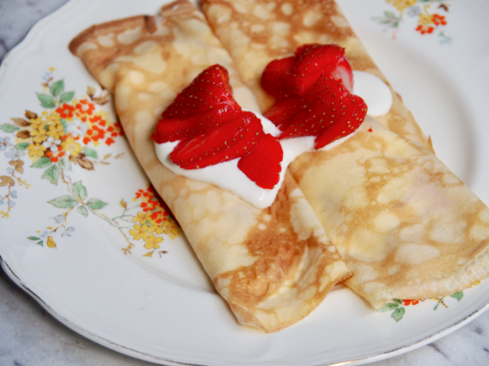 strawberry sour cream crepes on a plate