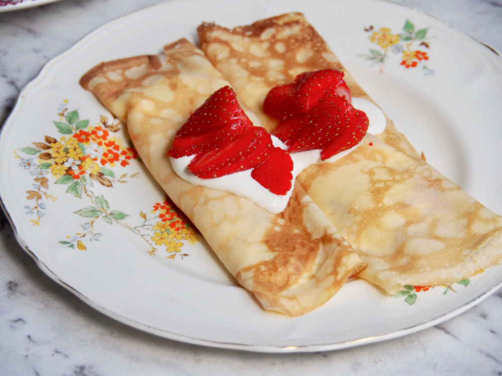 strawberry sour cream crepes on plate