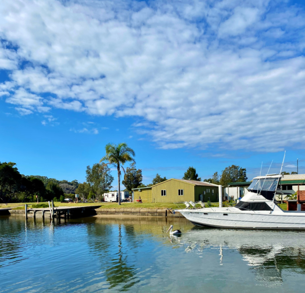 crookhaven river views with boat and pelican swimming