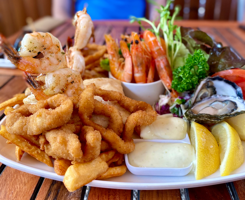 seafood basket with grilled fish prawns oysters and beer battered chips