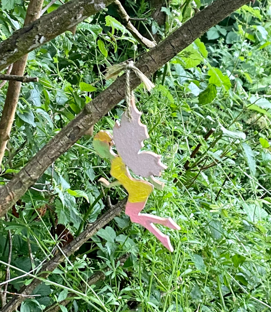 painted fairy hanging from a tree