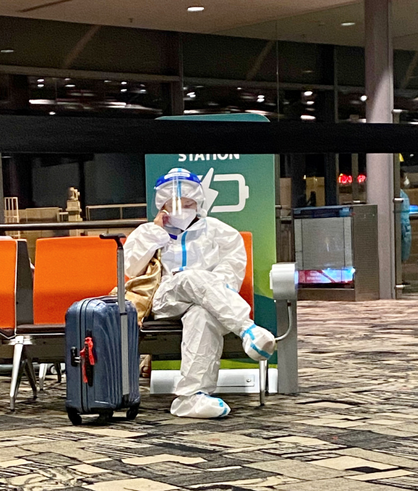 an airline passenger wearing full PPE