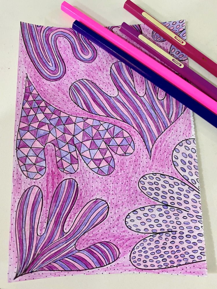 a page from a colouring in book in pink and purple