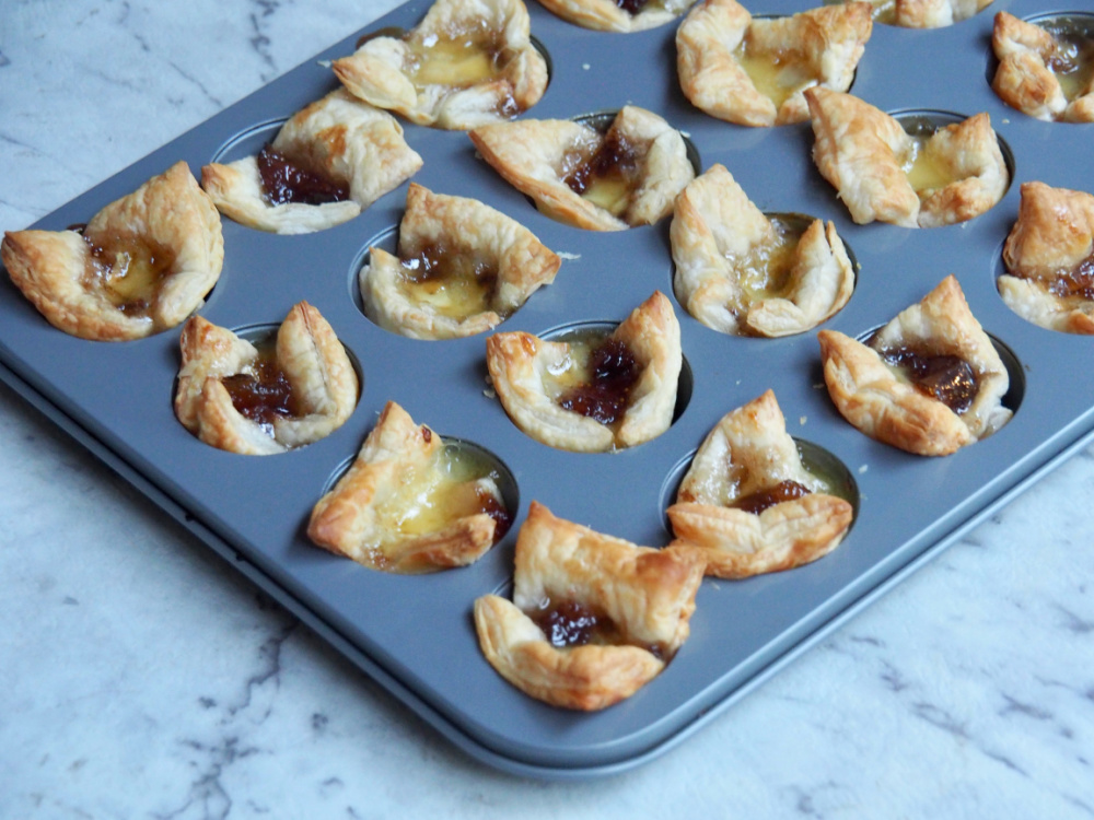 mini muffin tray with fig jam and brie bites