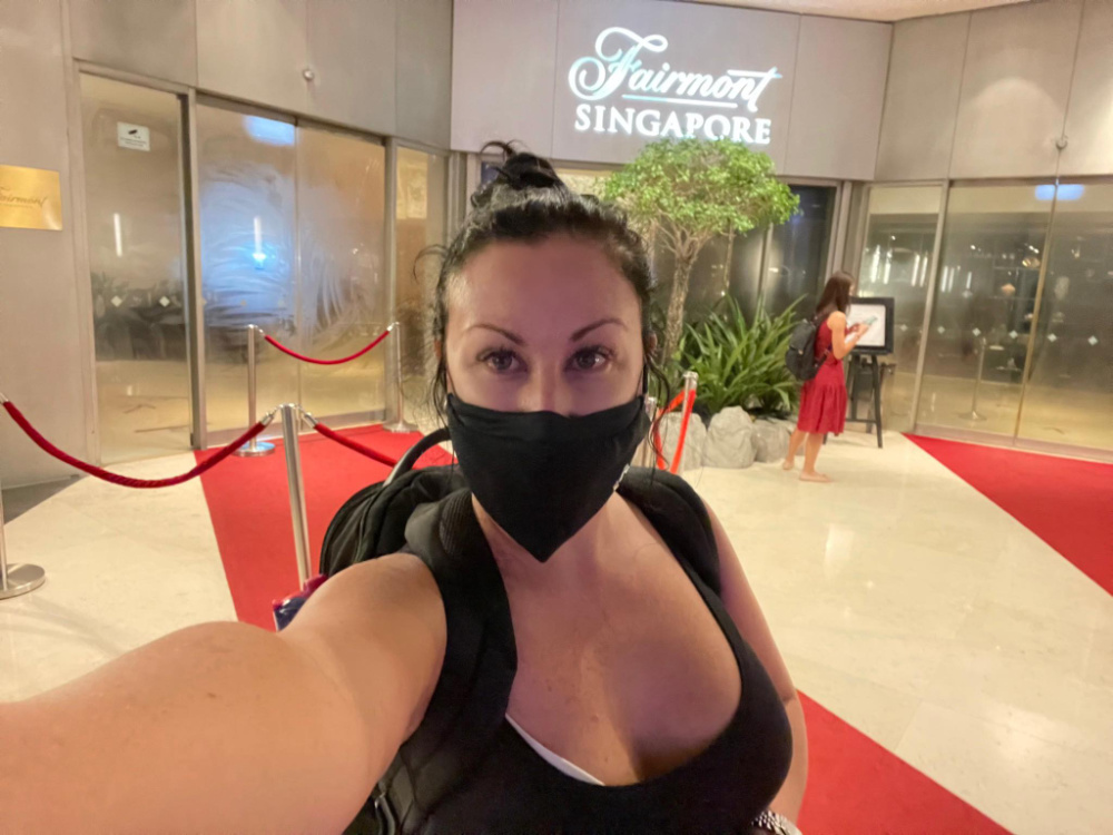 woman taking selfie outside Fairmont Singapore