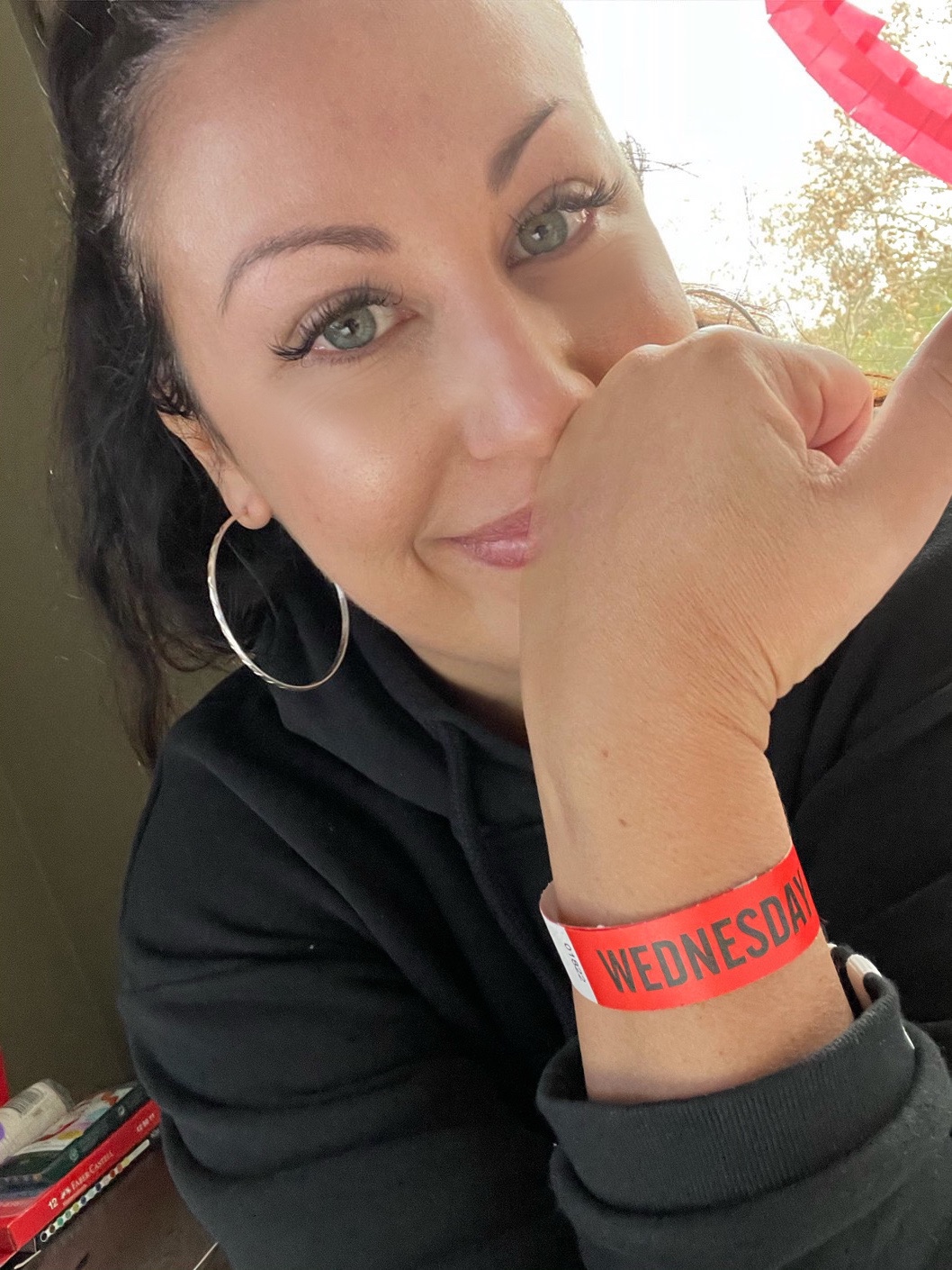 selfie of woman in hotel quarantine wearing release wrist band