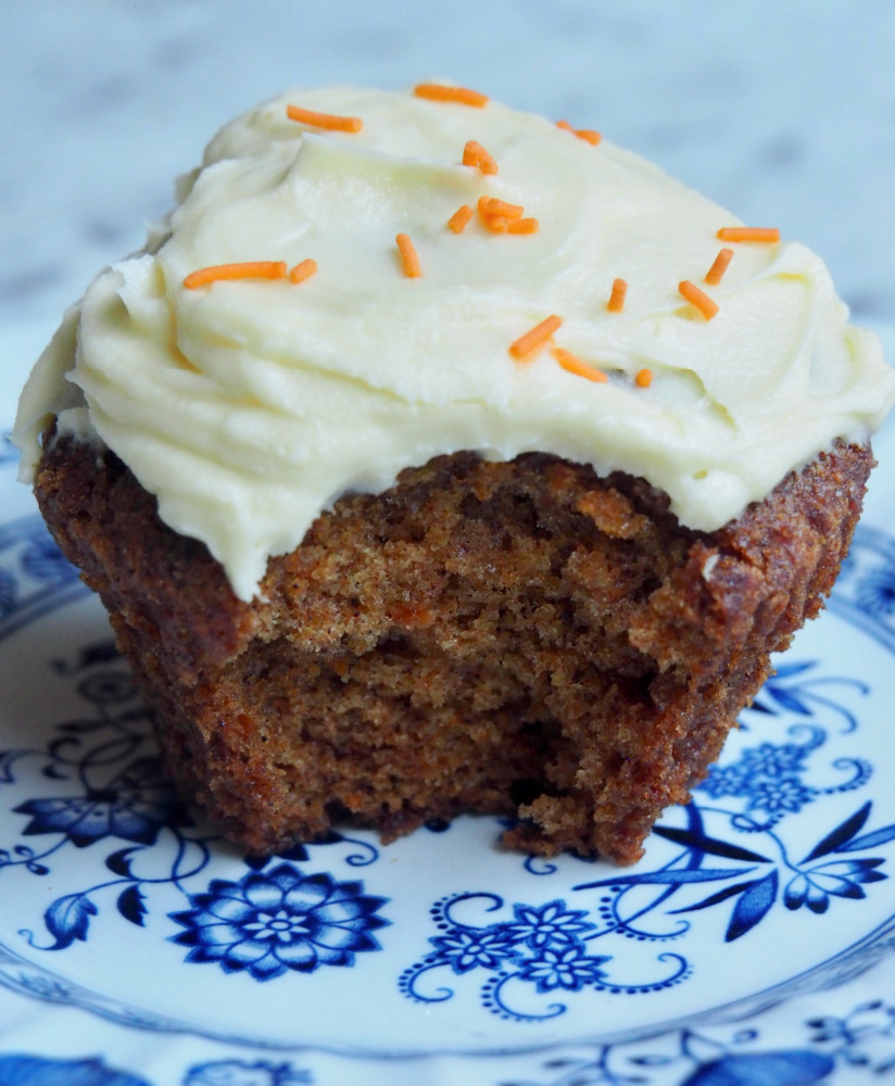 bite taken out of carrot cake cupcake