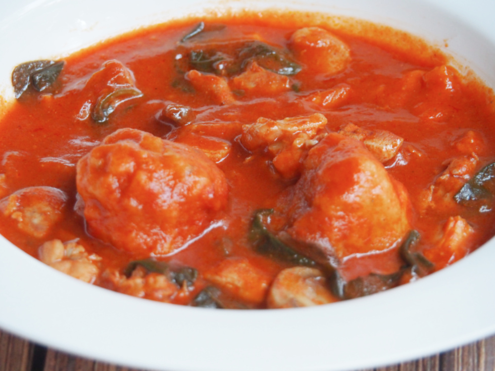 plate of paprika chicken stew with chive dumplings