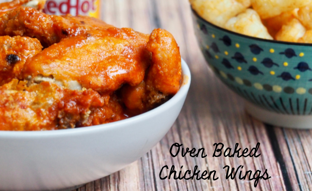 side view of oven baked chicken wings with bowl of tater tots in background