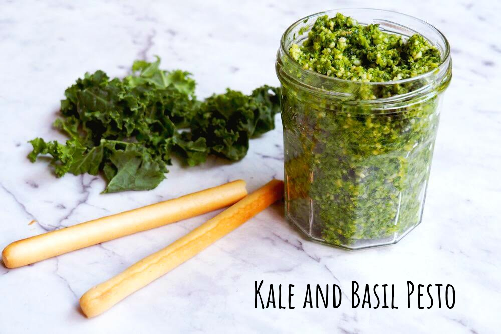 jar of kale and basil pesto with breadsticks