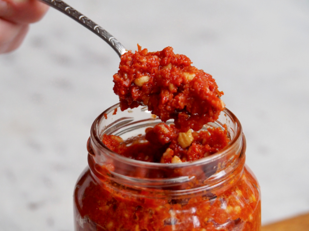 close up of spoonful vegan sun dried tomato pesto