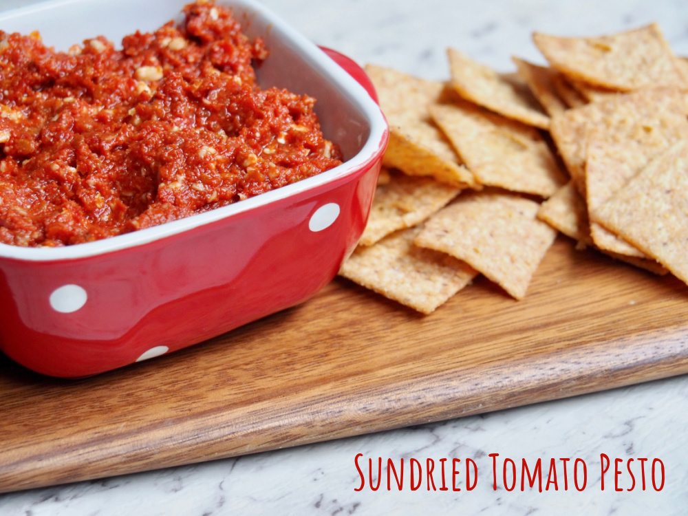 pot of sundried tomato pesto next to some crackers