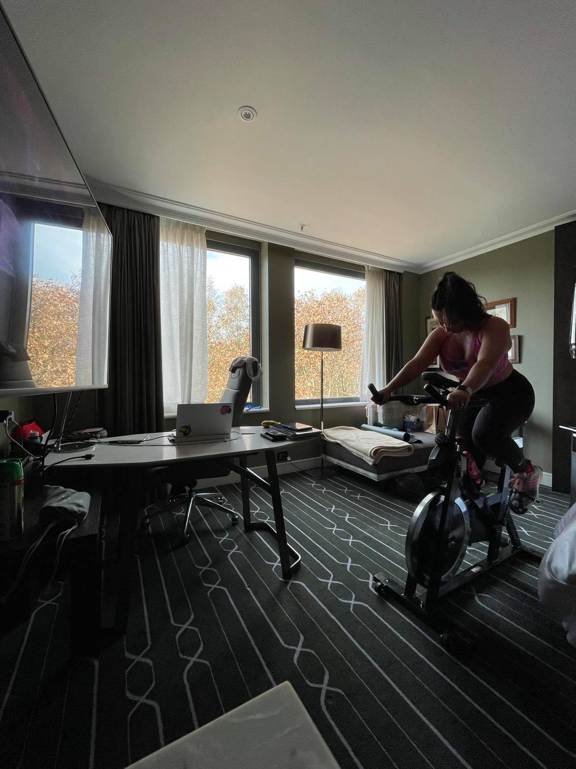 woman on exercise bike in hotel room