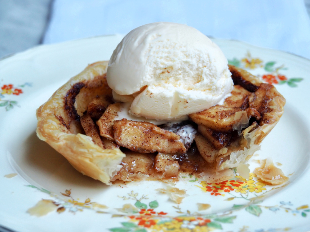 open topped apple pie with ice cream on top inside