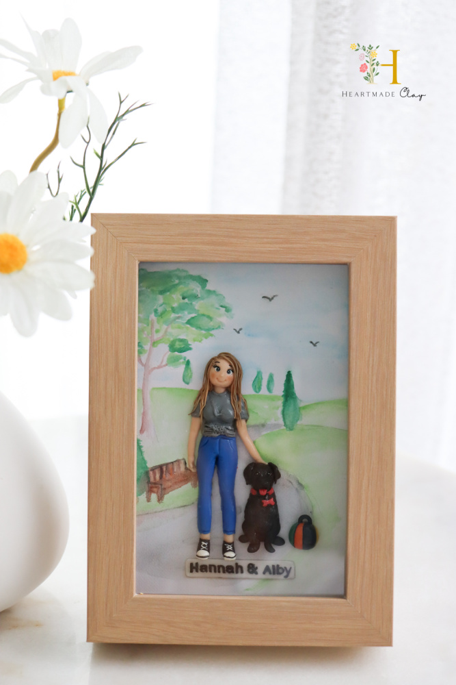 frame with polymer picture of woman and black dog