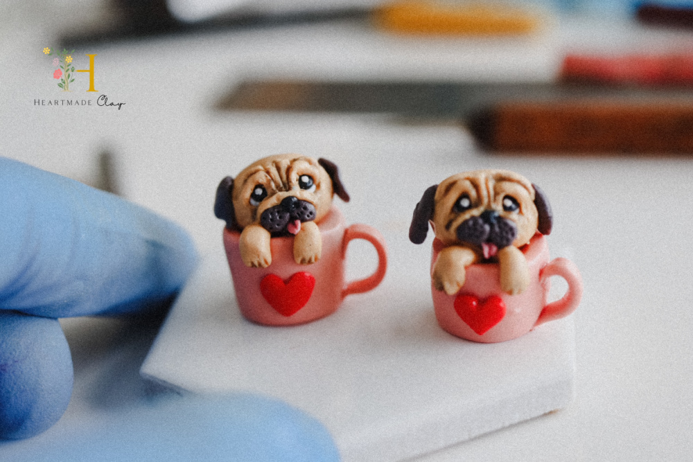 small polymer sculptures of pugs in mugs