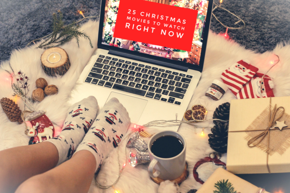 person sitting in front of a mac wearing Christmas socks watching a Christmas movie