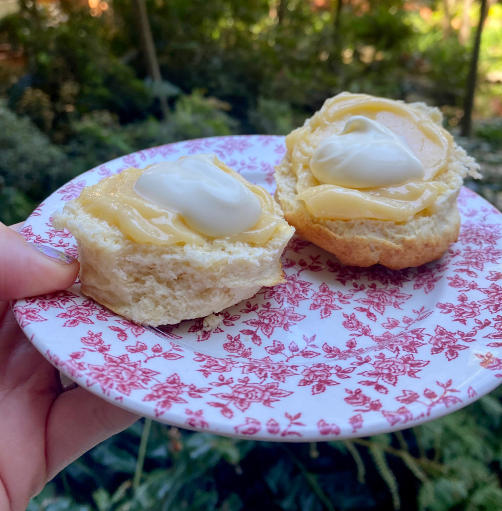 scone cut in half spread with lemon butter and cream